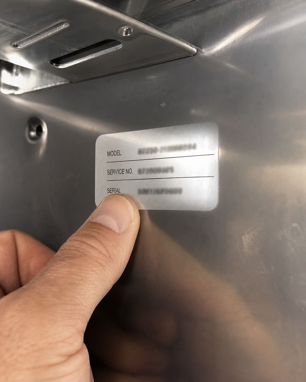 Close-up of a Sub-Zero model and serial number tag inside the refrigerator cavity in a Los Altos kitchen