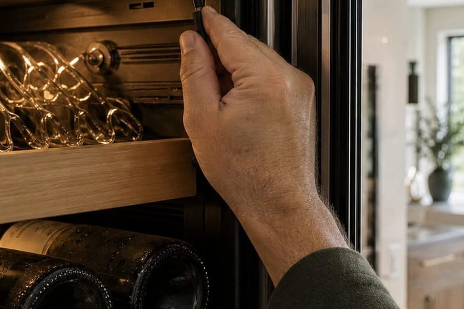 Technician flow-testing the water inlet valve of a Sub-Zero 550 built-in refrigerator in Los Altos